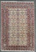 A hand-knotted North West Persian rug, central field with all-over scrolling floral pattern and
