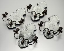 A set of four etched mirror glass twin-light candle sconces, each cartouche-shaped mirror issuing