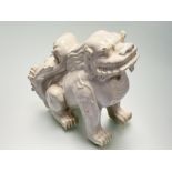 A Chinese white-glazed pottery model of a lion dog, probably 20th century. Height 26cm.