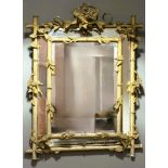 A 19th century painted and parcel-gilt carved wood and composition mirror-framed wall mirror, the