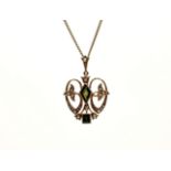 An Edwardian 15ct gold, green tourmaline and seed pearl pendant with brooch fitting, of open