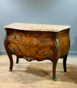 A 20thc. walnut and rosewood veneered bombe commode in the Louis XVI style, with shaped marble top