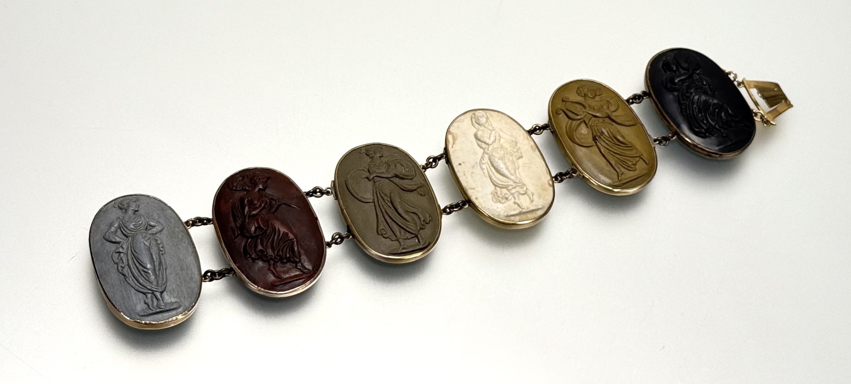 A 19th century lava cameo bracelet, formed of six oval cameos carved with Classical Muses, mounted - Image 3 of 3