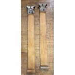 A pair of pitch pine pilasters with Corinthian capitals, tapering, the capitals of carved wood and