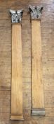 A pair of pitch pine pilasters with Corinthian capitals, tapering, the capitals of carved wood and