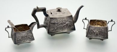 A sterling silver three piece tea service, probably Indian, c. 1900, each piece repousse with