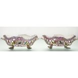 A pair of K.P.M. Berlin porcelain baskets, 19th century, oval, reticulated and floral-encrusted,