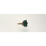 A green tourmaline and diamond dress ring, the baguette-cut tourmaline claw-set between Deco-