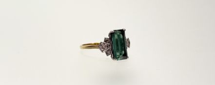 A green tourmaline and diamond dress ring, the baguette-cut tourmaline claw-set between Deco-