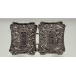 A Chinese silver belt buckle, late 19th / early 20th century, the paired elements of shaped