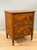An early 19thc flame mahogany chest, fitted two moulded front drawers, with original brass ring