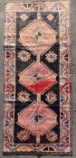 A hand-knotted Persian Lori carpet, central panel with three red medallions surrounded by stylized