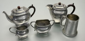 A Talbot Pewter four piece coffee service comprising, a coffee pot (h-18cm), a teapot (h-15cm), a