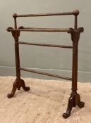 An Edwardian mahogany five-bar towel rail, raised on fluted columns and splayed supports: H. 86cm L.