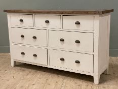 A modern painted hardwood sideboard by Reclaimed, fitted with seven drawers to front raised on