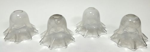 A set of four Art Nouveau-style hand-blown art glass lamp shades with a pearlescent finish,