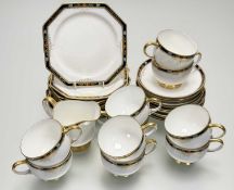 A Paragon part tea service in a flower head and gilt on cobalt blue rim pattern comprising, ten