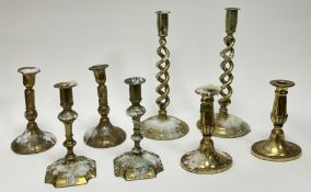 A collection of 19th and 20thc brass candlesticks, comprising a pair of barley twist candlesticks