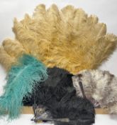 A collection of early 20thc ostrich feather fans, comprising a large extravagent peach fan with
