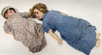 A pair of early 20thc French SFBJ bisque headed dolls, both with painted features, open mouths,