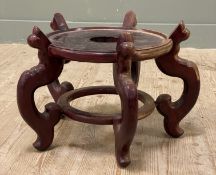 A large Chinese hardwood vase stand, circular top raised on five shaped supports united by