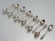A Sheffield set of twelve silver rat-tail pattern tea spoons: l. 10.5cm with engraved initials H.B.S