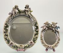 A graduated near pair of late 19th/early 20th century German hard paste porcelain vanity bevelled