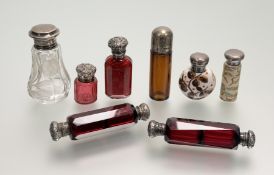 A collection of silver topped perfume bottles, etc., to include two Victorian faceted ruby glass