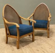 A pair 20th century beech bergere armchairs, pointed arch backs with rattan and shaped arms, blue