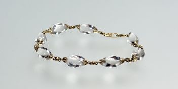 A 9ct gold bracelet mounted with eight spiral rock crystals and lobster claw fastening, signed: d. x