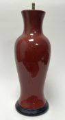 A Mid-Century ceramic table lamp of baluster form, finished in an oxblood/sang-de-boeuf style glaze,