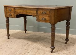 A Victorian oak writing table, inset skiver to top lifting to reveal fitted interior, with four
