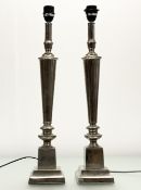 A pair of 20thc silver metal candlestick style table lamps with pedestal bases. (h-63cm) (2)