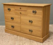 A modern oak sideboard by Laura Ashley, fitted with eight drawers to front raised on a plinth