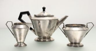A Sheffield silver Art Deco three piece tea service of circualr tapered form on a stepped circular