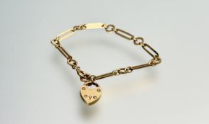 A 9ct gold oval and circular cast link chain bracelet with ring fastening and a cast 9ct gold