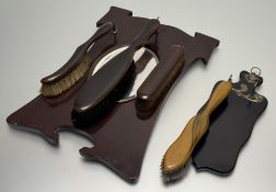 A 1930's/40's carved wooden mirror panel with hooks hanging clothes brush trio (45cmx32cm)