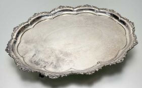 A epns scalloped drinks bottle stand with floral, beaded and leaf border with engraved centre on