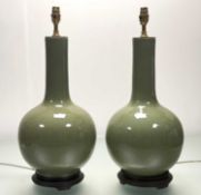 A pair of large Chinese celadon-glazed porcelain vasiform table lamps, 20th century, each of flask