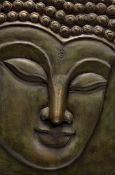 A decorative carved wooden plaque of a Thai Buddha head portrait, unframed. (46cmx31cm)