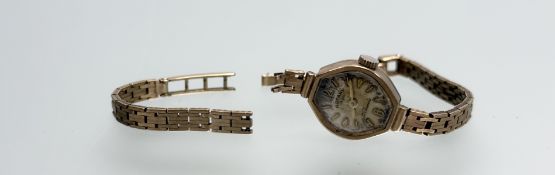 A vintage 9ct gold Rotary wristwatch with silvered dial and arabic numerals at hour and half-hour: