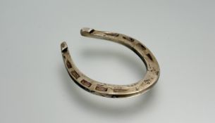 A Sheffield silver lucky horseshoe paperweight: l. x 6cm in presentation red velvet and satin