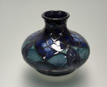 A late 20thc Moorcroft Lattice pattern green/ blue glazed squat vase, impressed marks, initialled WM