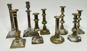 A collection of late 19th and 20thc assorted brass candlesticks, comprising a pair of baluster