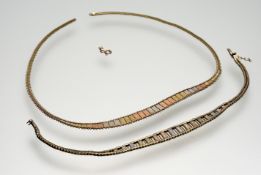 A 9ct three coloured gold graduated panel necklace- fastening damaged: l. x 18cm 7.1g with