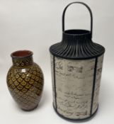 A decorative candle lantern with postal script motifs to fabric body, flanked by black painted