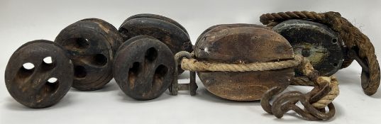 A collection of 19thc Nautical equipment, comprising a pair of double pulleys, each with hooks and