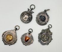 A collection of five various silver prize medals to include two Bamburghshire League Challenge Cup