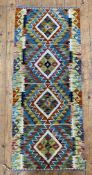 A hand-knotted Chobi kilim runner, central panel with repeating geometric and four diamond motifs,