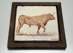 A framed 20thc Spanish ceramic hand-painted tile depicting a bull, signed barroco seville bottom